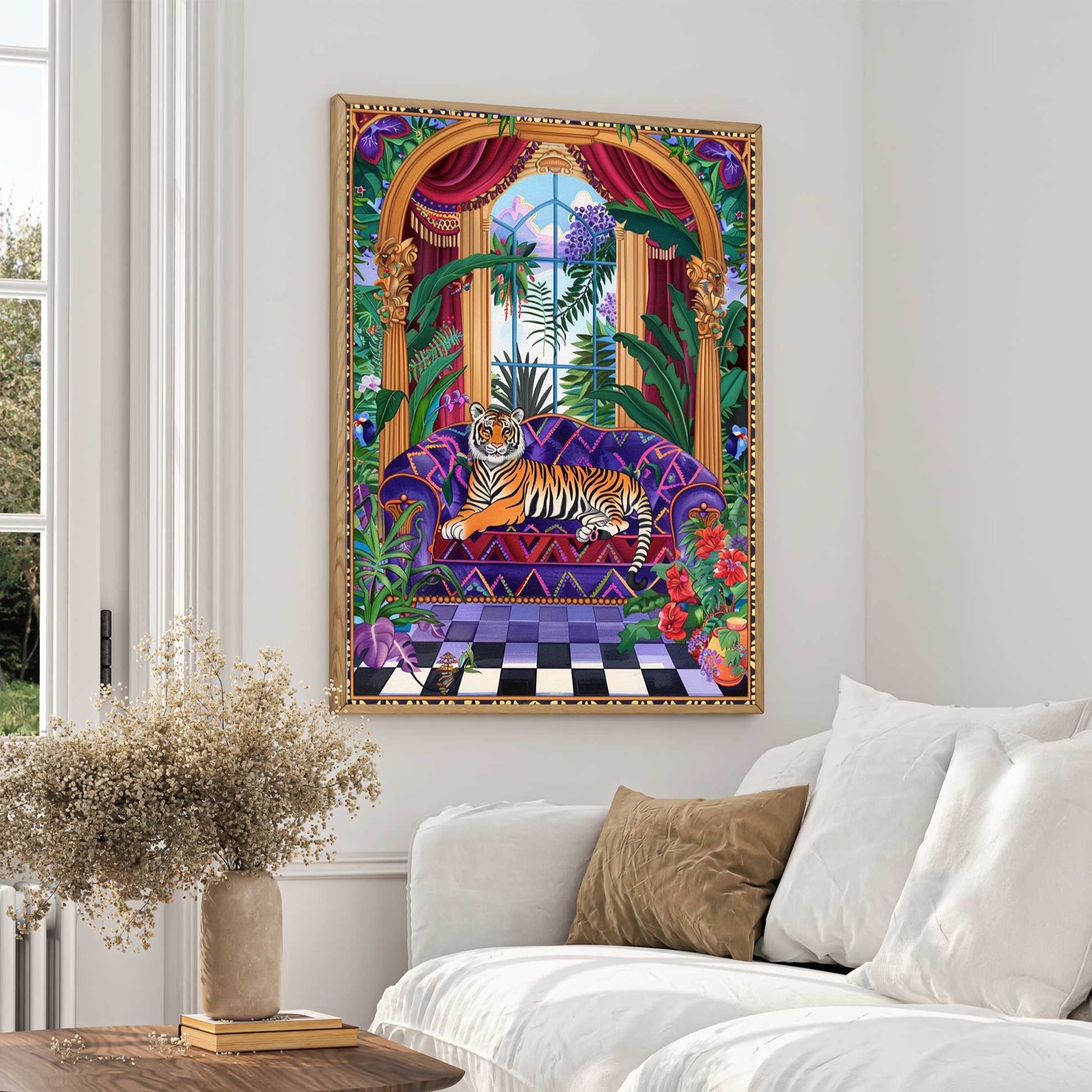 A vibrant and colorful maximalist art print featuring a majestic tiger lounging on a purple patterned couch. The scene is set in an opulent room with large windows showing a lush garden outside. The room is filled with detailed tropical plants, red curtains, and a checkerboard floor, creating an exotic and luxurious ambiance