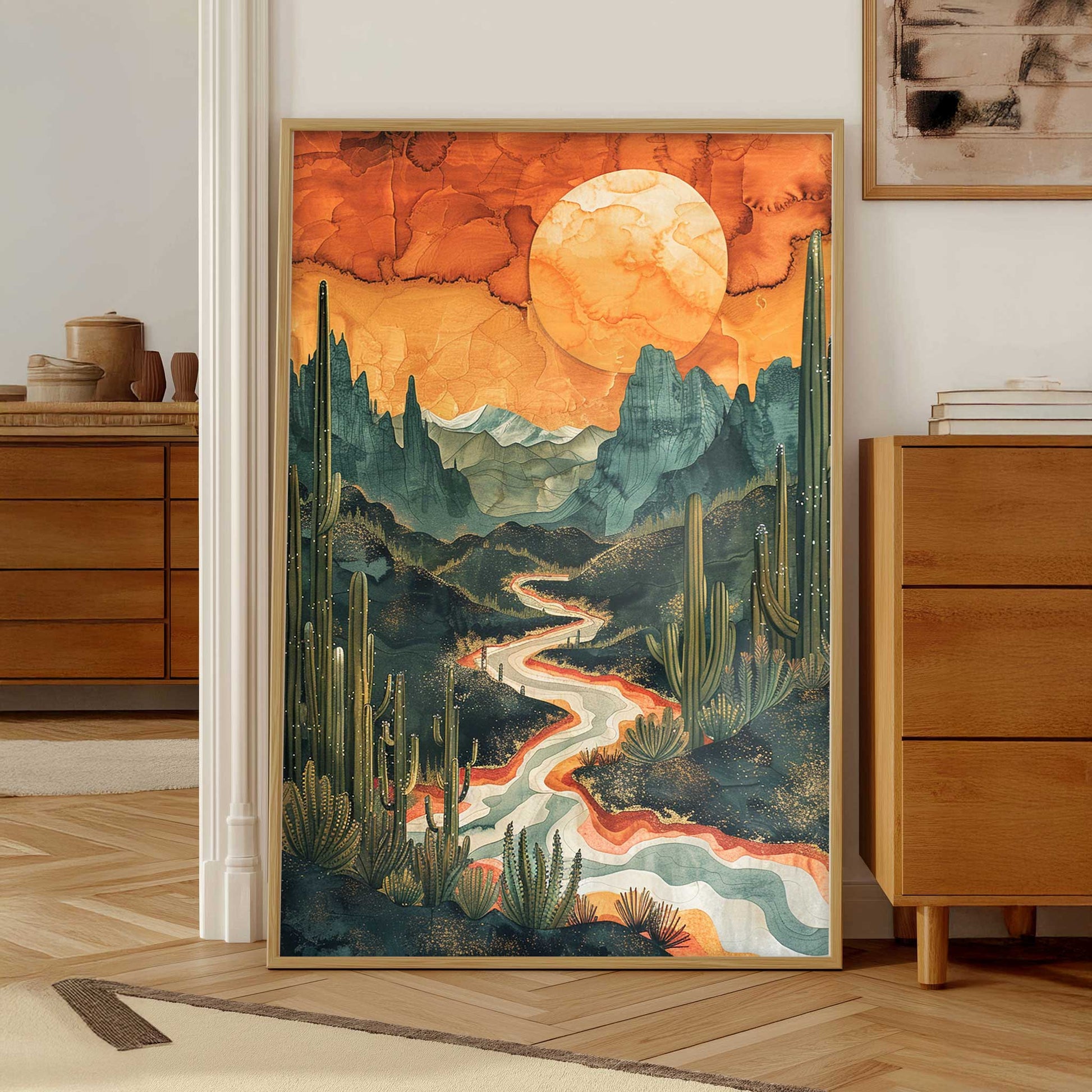  A desert landscape with cacti and a winding river Desert Canyon Wall Art, Sunset Landscape Poster, placed on a wooden floor.