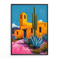 Agave Cactus Print Desert Landscape Poster Framed artwork of a colorful desert scene with a building, cactus, and agave plants.