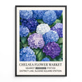 Blue Hydrangea Floral Wall Art Print features clusters of blue and purple hydrangea blooms around a garden path, in a soft, painted style. Framed poster of blue and purple hydrangeas 