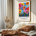 Bold floral wall art print with abstract flower shapes and strong colour contrast. on a bedroom wall