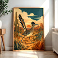 A mid-century modern graphic art print of a Greater Roadrunner bird running through a Southwest desert landscape with saguaro cacti, flat-topped mesas, and a warm terracotta sun.