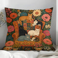 Floral folk art cat throw pillow with cats on a vintage armchair surrounded by colourful flowers