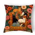 Floral folk art cat throw pillow with cats on a vintage armchair surrounded by colourful flowers