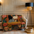 Floral cat woven throw blanket with six cats on a patterned armchair surrounded by flowers