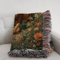 Decorative pillow with floral pattern and fringes on a white couch