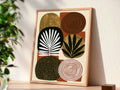 Mid century modern boho abstract art print featuring a grid arrangement of six organic, rounded geometric shapes on a terracotta rust background. Graphic textures include gold foil arches, a black spiral circle, a white concentric spiral, a gold circle with a black leaf sprig, a black oval with a white palm frond, and a dark brown oval covered in gold dots.