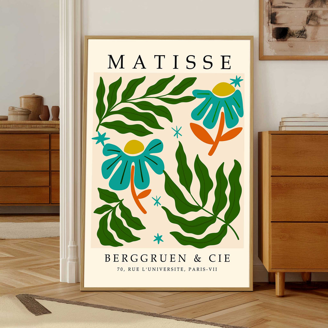 
Matisse botanical print with flowers, leaves and cut out style shapesFramed Matisse poster with floral design and text on a beige background
