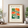 Matisse tulip print with orange tulips and green botanical leaves Framed Matisse poster with orange flowers and green leaves on a beige background