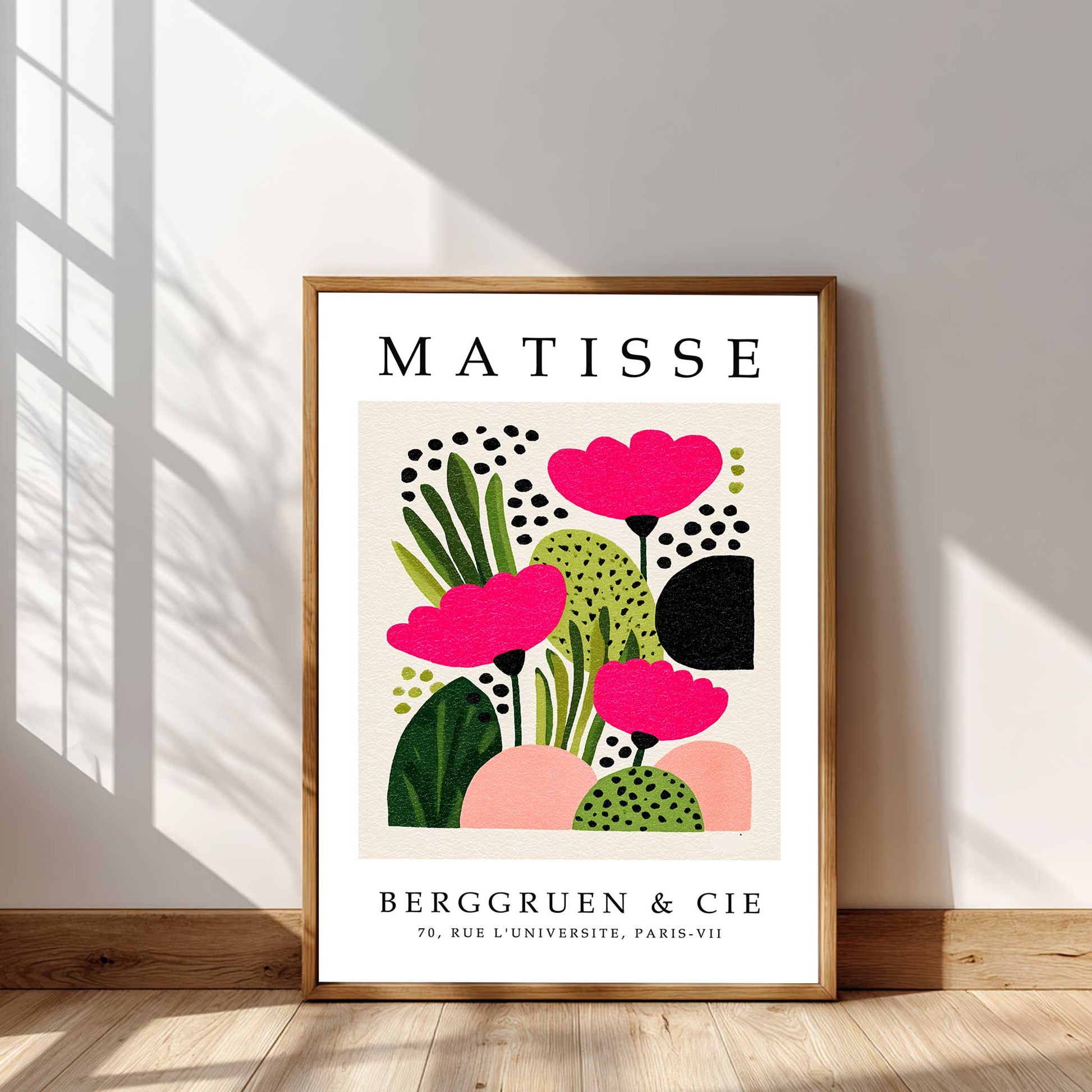 
Matisse pink flower print with pink flowers, green botanical shapes and abstract floral forms. Pink flower wall art, Scandinavian floral print, botanical wall art, Henri Matisse print, floral wall art and modern botanical print. Framed Matisse art print with pink flowers and green leaves on a white background, displayed in a room with sunlight filtering through a window.