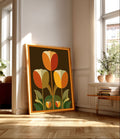 Symmetrical mid century modern graphic art print featuring three large geometric tulips in warm terracotta, ochre yellow, and cream petals with olive green leaves on a dark chocolate brown background enclosed by an orange border frame.