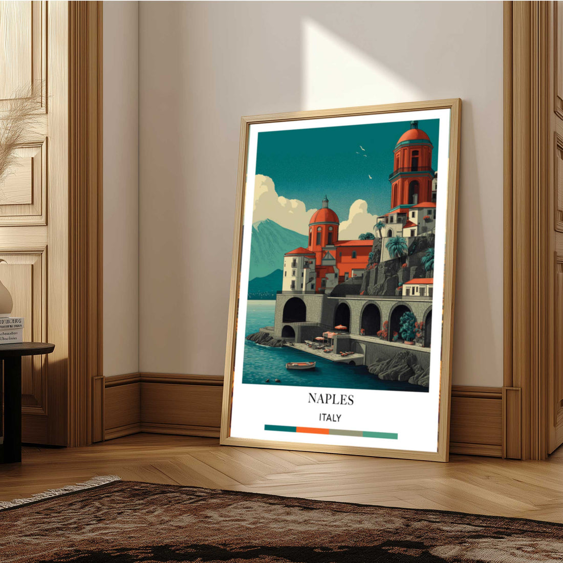 Framed artwork of a coastal scene with buildings and a body of water, labeled 'Naples, Italy'.