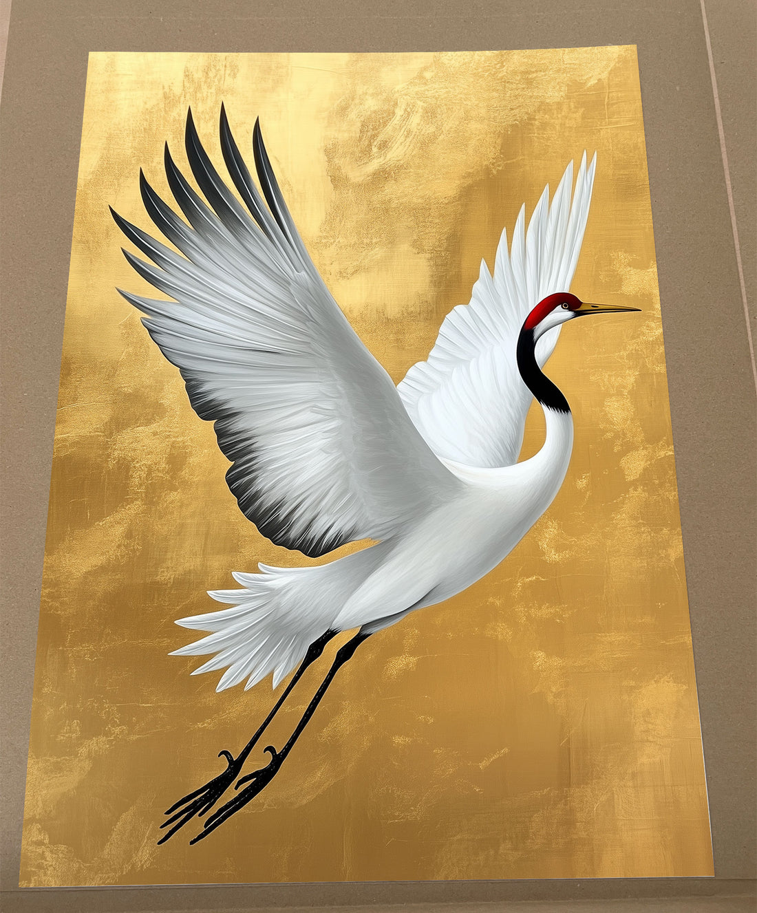 White red-crowned crane flying with wings spread wide against a textured gold background, Japanese crane art print.