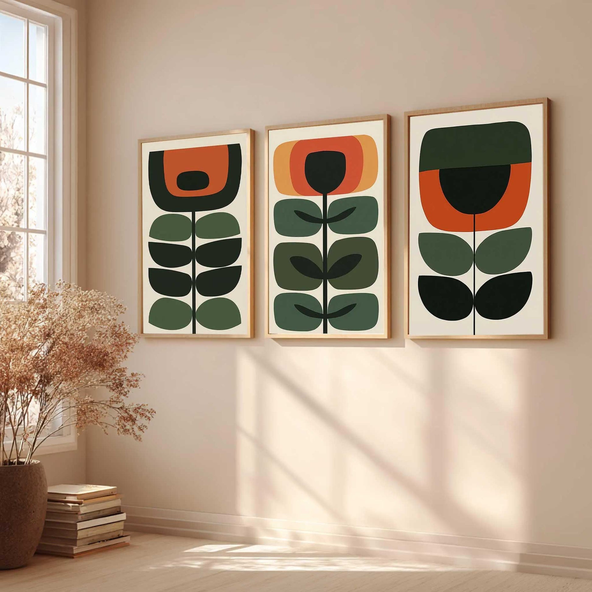 Mid century botanical wall art set of 3 with geometric green, burnt orange and ochre flowers and leaves on cream backgrounds.