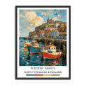 Whitby Harbour print with fishing boats, colourful waterfront buildings and Whitby Abbey in North Yorkshire Whitby Abbey in North Yorkshire, England, featuring a colorful painting of fishing boats in a harbor with seagulls flying overhead, presented in a black frame with a white mat.