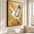 Japanese crane canvas wall art in a slim black floating frame, displayed at an angle in a cream living room