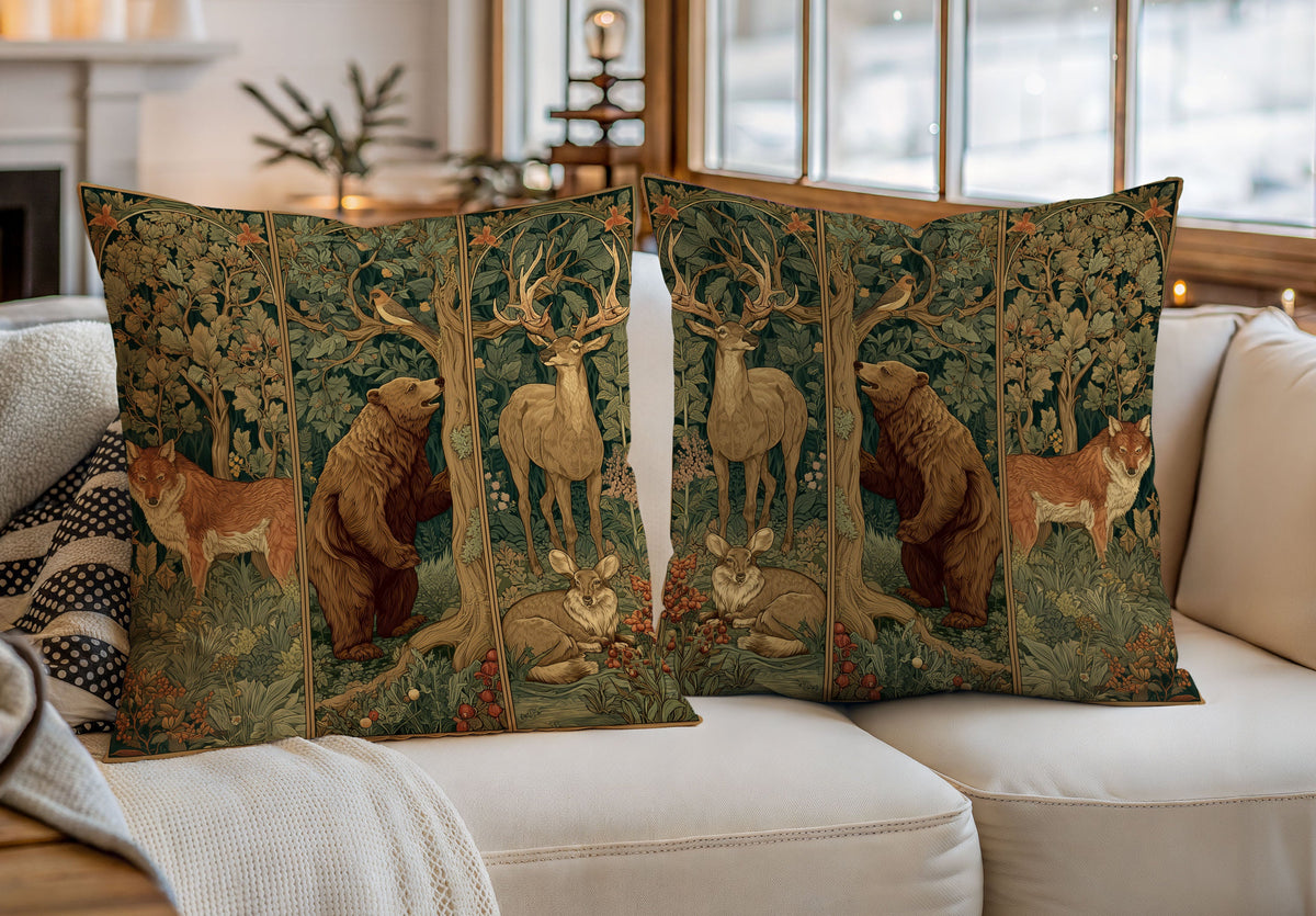 Two decorative throw pillows with a detailed woodland art print featuring deer, bears, and foxes, styled on a white sofa in a cozy, sunlit living room.