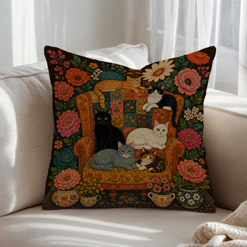 Floral folk art cat throw pillow with cats on a vintage armchair surrounded by colourful flowers