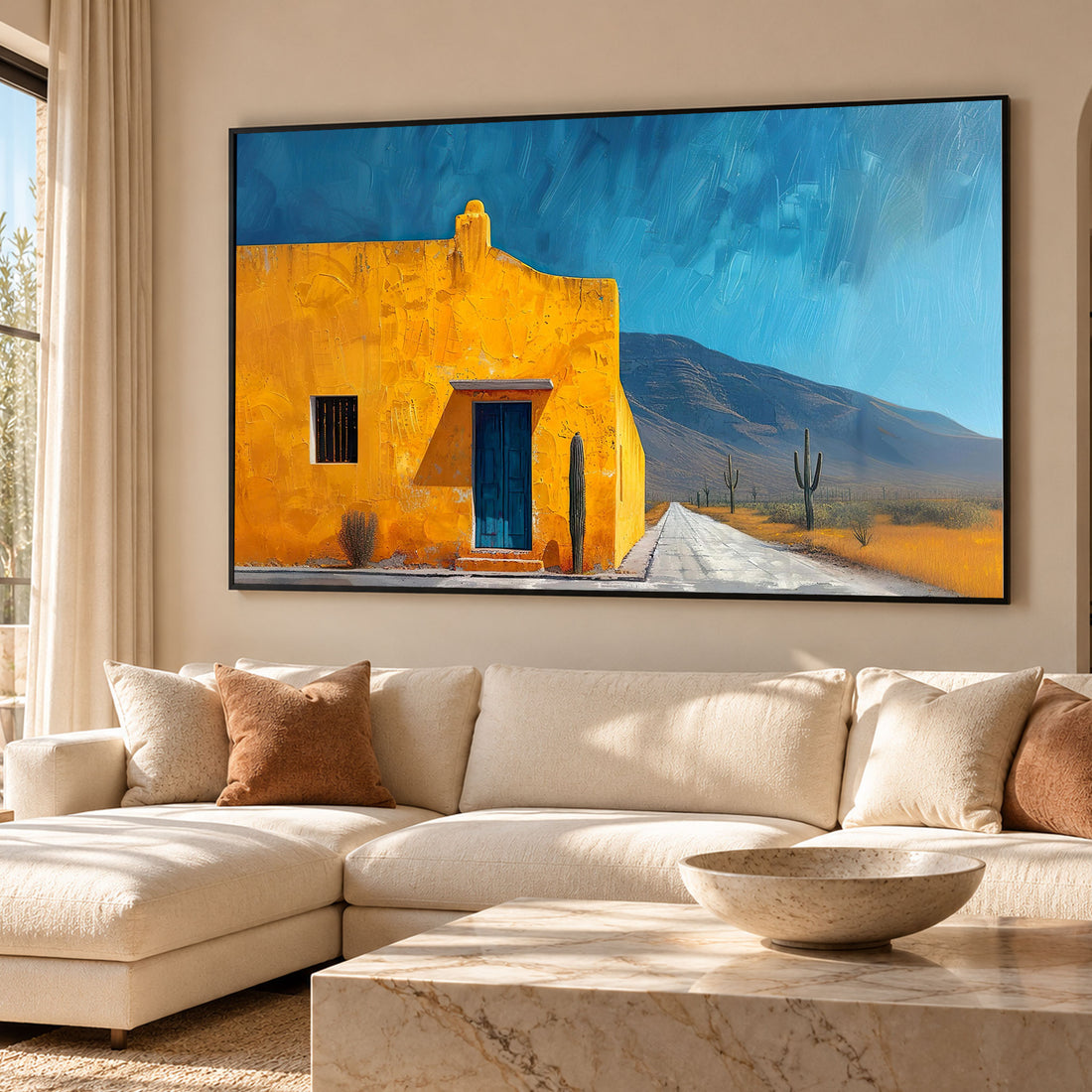 Desert house wall art featuring a southwest adobe building, open road, and cactus landscape under a clear blue sky. This art print suits living rooms, bedrooms, and everyday interior spaces. Available framed or unframed, it suits both modern and rustic home décor.